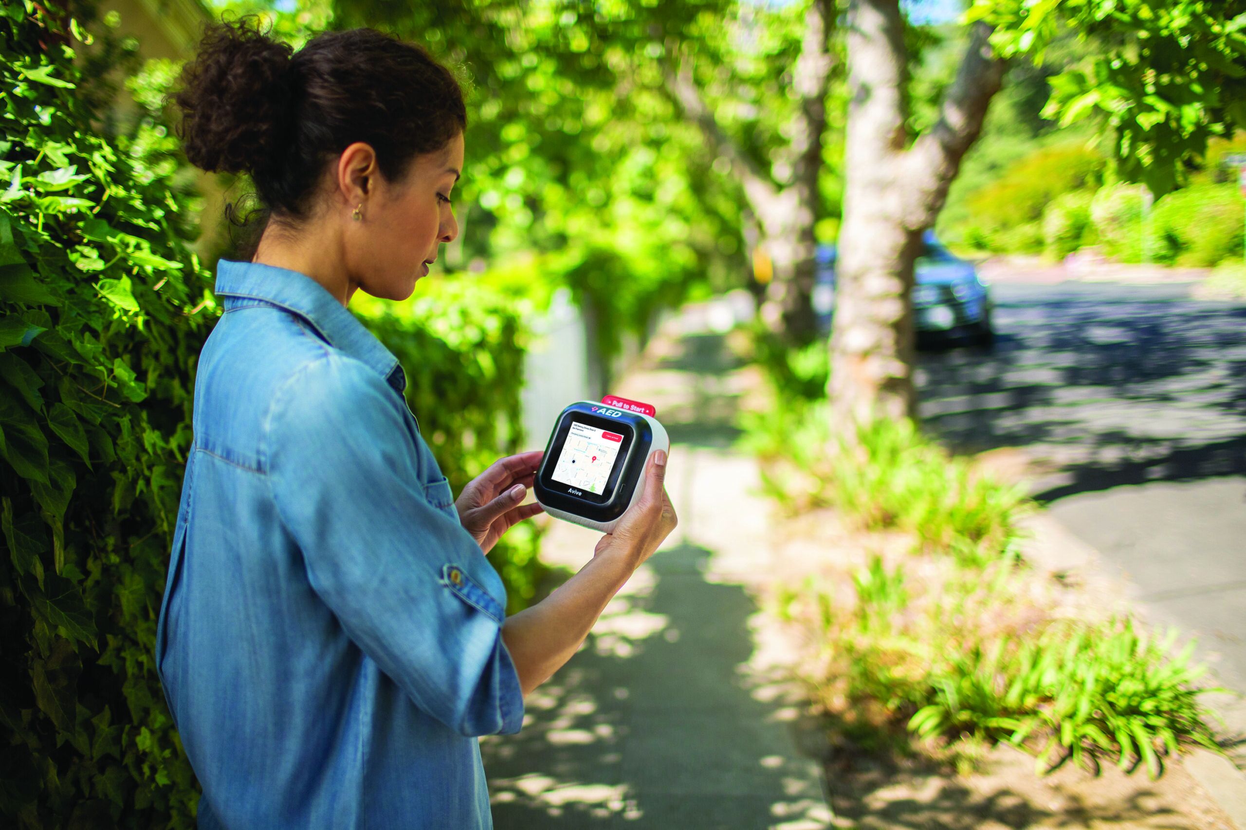 Woman holding AED